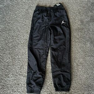 Boys black Jordan wind pants. Size Large.